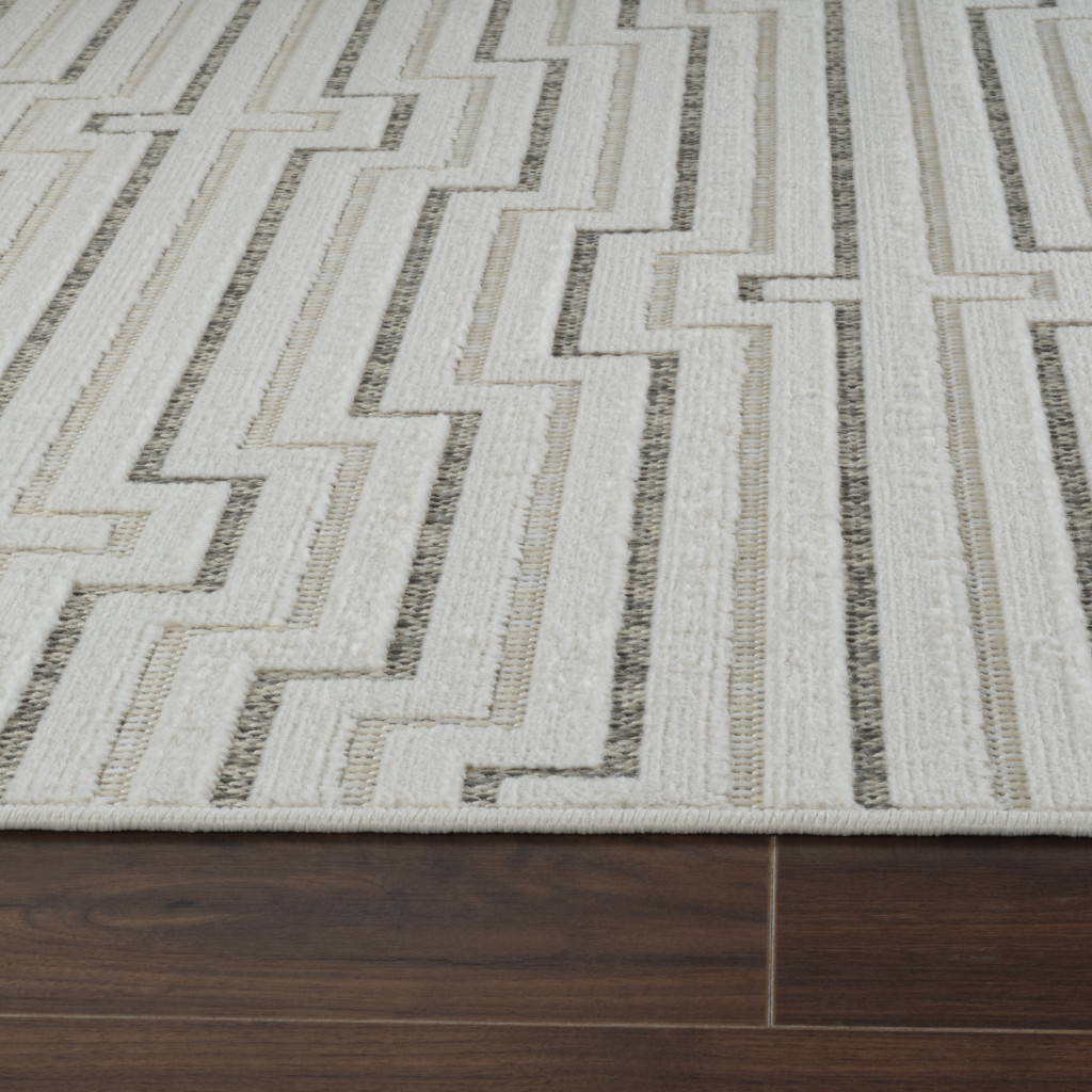 5' X 7' Cream and Beige Geometric Distressed Indoor Outdoor Area Rug