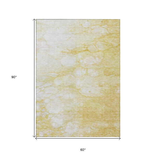 5' X 8' Gold Beige And Ivory Abstract Washable Indoor Outdoor Area Rug