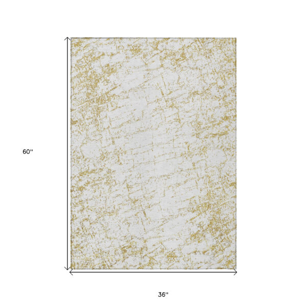 3' X 5' Gold And Ivory Abstract Washable Indoor Outdoor Area Rug