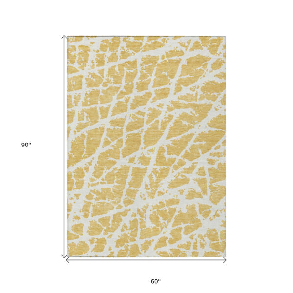 5' X 8' Gold and White Abstract Washable Non Skid Indoor Outdoor Area Rug