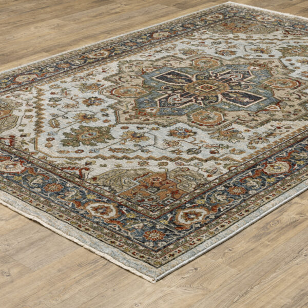 6' X 9' Ivory Beige Blue Orange Gold Green Grey And Rust Oriental Power Loom Stain Resistant Area Rug With Fringe