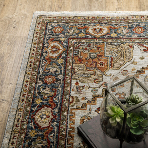 6' X 9' Ivory Beige Blue Orange Gold Green Grey And Rust Oriental Power Loom Stain Resistant Area Rug With Fringe